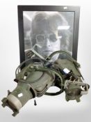 A framed John Lennon poster and two metal spotlights.