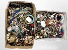 Two boxes of assorted costume jewellery.