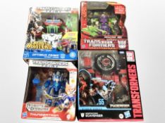 A group of Hasbro and Tomy Transformers action figures.