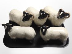 Five ceramic rams/ewes, largest 22cm long.