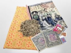 A box containing throws, helmets, miniature Persian carpet coasters, etc.