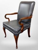 A reproduction armchair in studded grey leather