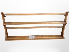An Ercol stained elm plate rack,