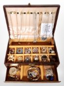 A contemporary faux leather jewellery casket containing costume necklaces, brooches,