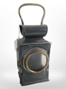 An antique tin and brass candle lamp, height 24cm.