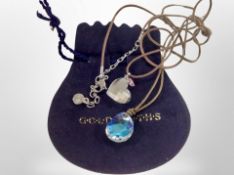 A Swarovski crystal heart and butterfly pendant on leather cord, together with one other similar.