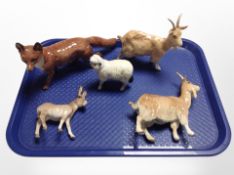 A Beswick fox, two goats, sheep, and donkey foal.
