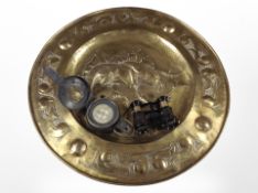 An embossed brass charger, diameter 48cm, together with a Mk III compass,