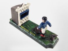 A cast-iron novelty football bank, length 24cm.