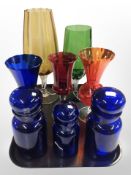 A group of contemporary oversized goblet-shaped glass vases, three Belgian blue glass lidded jars.