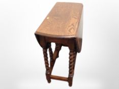 An Edwardian oak barley twist gate leg table
