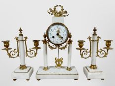 A 19th century French white marble and gilt metal portico clock garniture, striking on a bell,