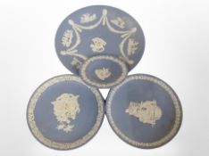 Four Wedgwood blue and white Jasperware plates, largest 23cm.