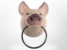 A cast-iron pig head with metal ring, length 13cm from the wall.