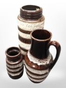 A West German pottery stick pot, height 41cm, together with a further jug and a vase.