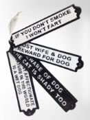 Four cast-iron plaques, 'Beware of dog', etc., largest 32cm long.