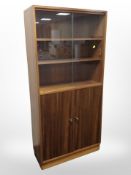 A teak sliding glass door open bookcase,