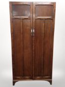 An Edwardian panelled oak wardrobe,