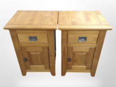 A pair of pine effect bedside cabinets,