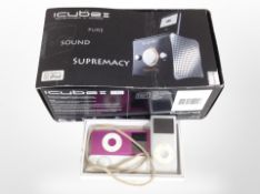 An iCube II speaker and dock in box, together with two Apple iPods and an iPod shuffle.