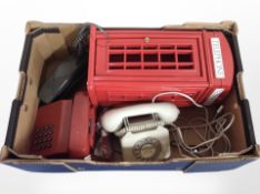 A box of vintage telephones