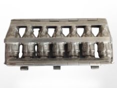 A vintage diecast metal chocolate mould, width 22cm.
