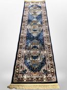 A machine made Turkish runner on blue ground,