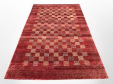 A machine-made carpet on red ground,