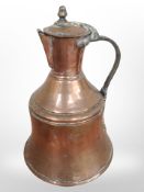 A 19th-century copper jug, height 31cm.