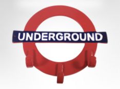 A cast-iron underground coat rack, length 34cm.