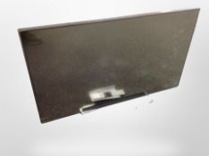 A Toshiba 42 inch LCD TV with lead and remote