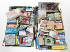 Two boxes containing a large quantity of playing card sets and games.