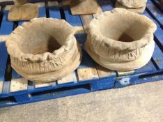 A pair of concrete sack planters, height 24cm.