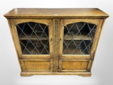 A reproduction glazed oak side cabinet,