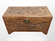 A heavily carved camphor wood blanket chest,