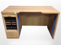 A Danish oak and teak veneered desk, with tambour front pedestal,