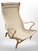 A Danish bentwood and canvas armchair, lacking cushions,