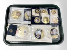 A group of gold-plated royal commemorative coins.
