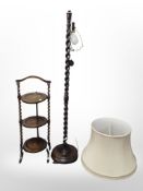 An Edwardian oak cake stand and a standard lamp