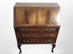 A reproduction mahogany writing bureau on pad feet,