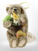 A Steiff mohair teddy bear with tags and protective cloth bag.