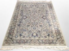 A machine made Persian style rug on green ground,