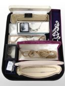 A group of faux pearl necklaces, brooches, and other costume jewellery.