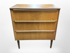 A Danish teak and MDF three drawer chest,