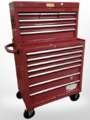 An enameled metal mechanic's storage trolley, with multiple drawers containing some tools.