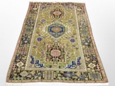 A Caucasian rug on green ground,