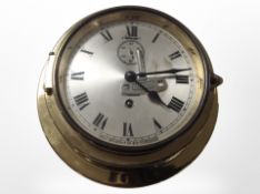 A Viking brass-cased ship's timepiece with key, diameter 22cm.