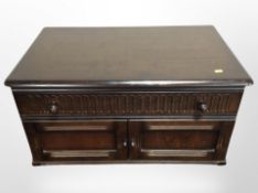 An Ercol stained elm low unit,