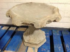 A concrete octagonal bird bath, height 42cm.
