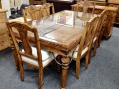 A colonial-style carved dining table with plate glass top, 182cm long x 106cm wide x 78cm high,